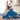White dog laying down and playing with blue hammerhead shark plush dog toy