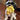 Small dog holding yellow hedgehog Tiny-Tuff dog toy in its mouth