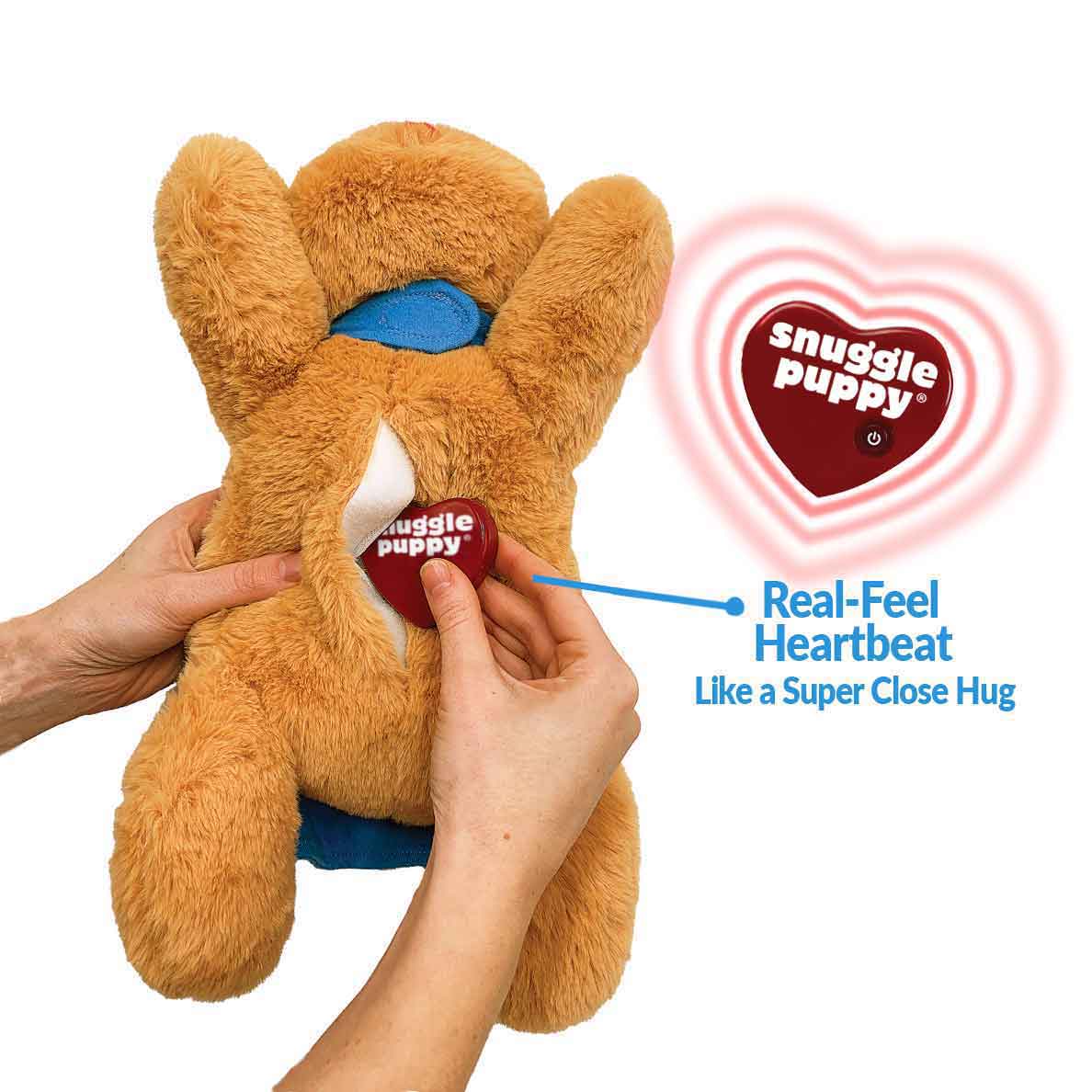 Person inserting a Real-Feel Heartbeat into a Snuggle Puppy Hero's belly pocket