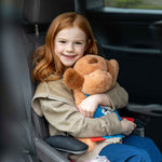 Young girl sitting in car hugging her Snuggle Puppy Hero