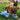 Brown dog laying in grass and chewing blue bear soft dog toy