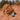 Golden retriever on a hill in the desert playing with green cactus dog toy