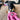 Black dog in bandana playing with brown Tender-Tuffs dog astronaut toy in pink space suit with heart on it