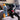 Black Labrador sitting next to rocket shaped Tender-Tuffs water bottle crinkle dog toy